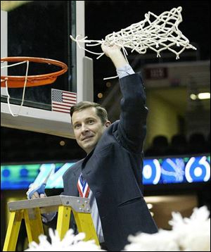 Bowling Green coach Curt Miller cuts down the net after his Falcons captured the MAC Tournament title, the eighth in school history, which is the most in the conference. Miller was recently named MAC coach of the year for the second straight season.