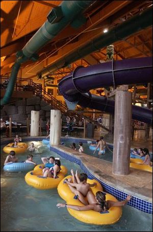 Visitors to the Great Wolf Lodge water park, above, relax while floating down Caribou Creek. 