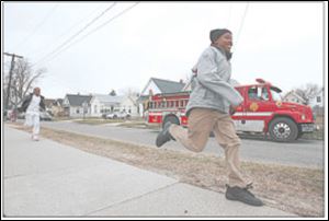 Devin Davis, 13, sprints home from school as firefighters patrol the area, part of a new effort with police after three recent reports of attempted child abductions.