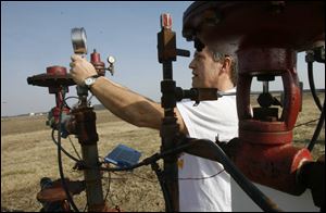 Jim Hoops monitors Ohio Gas Co. wells in Fulton County, including one on his own land. 