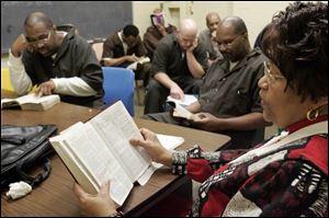 Diann Revels, an ordained minister, leads inmates during Bible study at the Lucas County jail. Some 35 volunteers with the Lucas County Jail Chaplaincy Committee conduct more than 20 Bible studies and church services each week. 