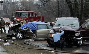 Emergency crews investigate a fatal accident on Secor Road south of Laskey Road.

