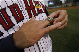 Mud Hens pitcher Steve Green tries on his ring in a pregame
ceremony last night at Fifth Third Field. 
