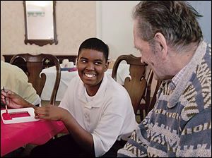 REG interact06p   Taylor Barber, 12 and in the seventh grade, paints a picture frame for Richard "Dick" Stotz, a resident.   Seventh and eighths graders from Leverette Junior High School at The Glendale, an assisted living and nursing care facility, in Toledo, Ohio on April 6, 2006. The Blade/Jetta Fraser