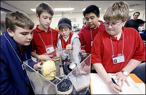 Troy Favorite, from left, Kyle Hatfield, Andrew Newmyer, Nick Sebeda, and Nicholas Schmidlin work on a smoke experiment. The students are working in a laboratory at Bowling Green State University as part of their study.