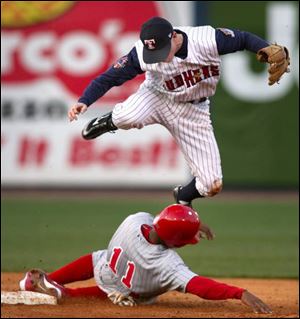 The Mud Hens  Kevin Hooper leaps over Scranton s Bobby Scales after tagging him out at second base.
Hooper went 3-for-4 at the plate with an RBI and a
runs scored.
