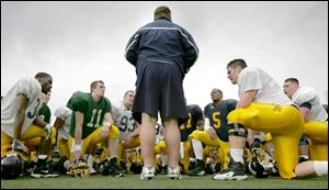 University of Toledo coach Tom Amstutz speaks to his players after the scrimmage at the Glass Bowl.
