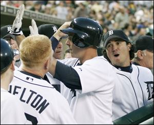 Brandon Inge, middle, is congratulated by his teammates after one of his two home runs during a victory over Cleveland.
