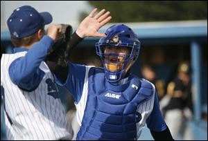 Blue Devils catcher Steve Decker gives a high-five to a teammate during a game against Northview. Decker is hitting .359. He s also done well as a relief pitcher.

