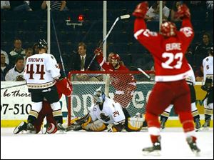 Gerry Burke (23) and Todd Jackson, behind net, celebrate after Matt Zultek puts a shot past Gwinnett goaltender Adam Berkhoel that gave Toledo a 3-1 advantage with 2:16 left in the first period.