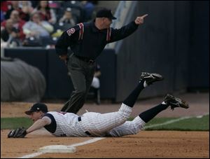 Mud Hens third baseman Mike Hessman can't stop a grounder from rolling down the left-field line during last night's game. 
Toledo didn't have much luck at the plate either as it was shut out by the Richmond Braves at Fifth Third Field.