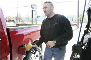 Brian Angerer fills up his pickup at the Sterling Store on Alexis Road with the fuel mix. 