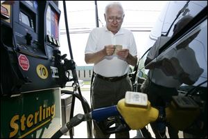Billy Miller of Trenton, Mich., drives out of his way to fill his minivan with ethanol. While the fuel costs less than gas, users cite U.S. dependence on foreign oil as a compelling reason to use it.