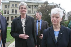 Sisters Marjorie Rudemiller, left, and Dorothy Thum leave the courthouse. Sister Marjorie thanked police and prosecutors.