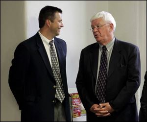 Cold-case investigators Steve Forrester, left, and Tom Ross chat
during a press conference after the verdict was announced.
