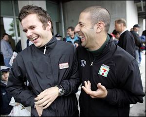 Indy Racing League drivers Dan Wheldon, left, and Tony Kanaan keep things loose following an interview at the Indianapolis Motor Speedway, where rain has been falling for several days.