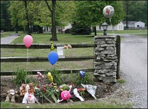 Outside of the Saunders  home at 1871 County Road E, toys and balloons pile up in a makeshift tribute to Lauren and Jacob.

