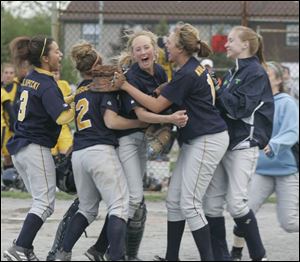 Whitmer players surround Amanda Temple after the Panthers won the Division I district championship yesterday.