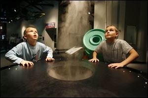 Evan and Blake Trusty of Indianapolis  check out the cloud maker at COSI Toledo.