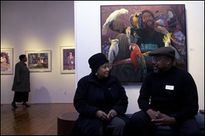 Marianne Payne of the Committee for Cultural Diversity at the Toledo Museum of Art chats with artist Wil Clay in January, 2005, near one of his paintings at 20 North Gallery in downtown Toledo.

