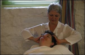 
Jan Archambeau of The Kerr House does her part in the  triple treat  massage being administered to Patty Flanagan. Laurie Hostetler, who opened The Kerr House in 1980, says the Grand Rapids, Ohio, spa has drawn people from all 50 states and many other countries.

