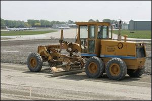 A runway at Metcalf Field in Wood County's Lake Township is graded prior to repaving.