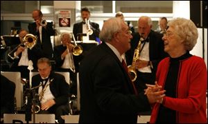 PLAYING THEIR SONG: Jerry and Dortha Baum dance to the saxy sounds of Jerry Sawicki, center, during the Toledo Opera's Blame the Champagne event.