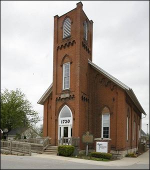 The old church with marker in front is now a hair spa.