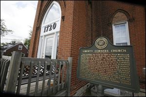 A historic marker that was paid for by St. Luke s and explains the history of Liberty Corners sits
in front of the old church.
