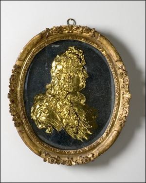 The cast glass medallion,
circa 1675, depicts King Louis
XIV, the Sun King.