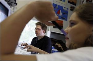 Chris Petri, with 15-year-old Marie Mowrey in the foreground, gets down to business during a study hall. 