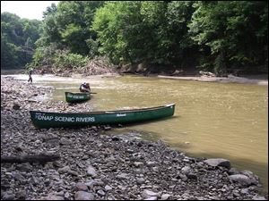 An Ohio Division of Natural Areas and Preserves canoe rests on a gravel bar in the upper Sandusky River during a recent scenic rivers get-acquainted trip.