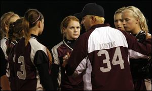 Genoa coach Tom Kontak talks to his team during the Division III state semifinal which started at 12:57 a.m. and ended at 2:37 a.m.