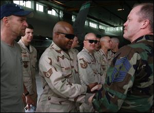 Command Chief Master Sgt. Chris Muncy, right, greets Sgt. Jeff Roberts on the soldiers  return to the Air National Guard 180th Tactical Wing based at Toledo Express Airport.
