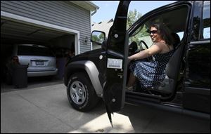 Taylor Blanchard climbs into her new Jeep Liberty before driving to Whitmer High School's ceremony on June 3.