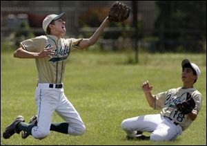 St. Mary Catholic Central second baseman Michael Iott makes a catch with backup from right fielder Cameron Sulfaro.