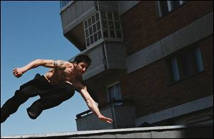 Leito (David Belle) moves among buildings in District B13.