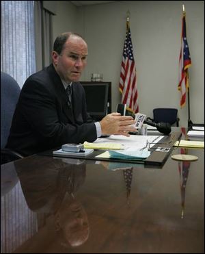 Mike Navarre, back behind the chief's desk at the Toledo police department, says he enjoys the job because it's 'fast-paced. There's never a dull moment.' He was ousted as chief Jan. 3 by Mayor Carty Finkbeiner and reappointed Tuesday. Though he admits the mayor is 'a difficult person to work for,' he will have 'no problems working for' Mr. Finkbeiner again. 