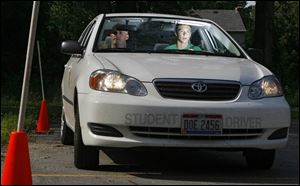 Ben Stalets, 16, of Rossford focuses intently on the task of parallel parking with driving instructor Chris Gerdeman.
