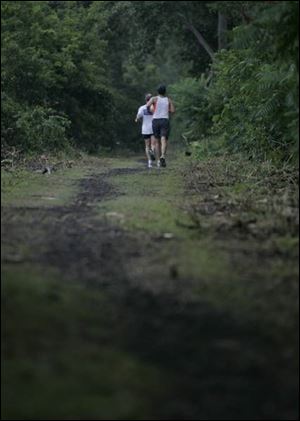 Jim Mohler, left, and Rod Johnson decided to jog the trail when rain postponed yesterday's Freedom Walk in Monroe.