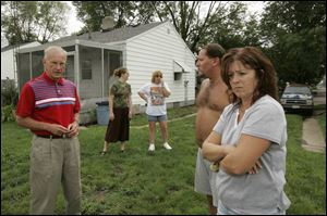 Mayor Carty Finkbeiner, left, visits with West Toledoans, from left, Kelly Wright, Deanna Penske, Brian Hairabedian, and Sandy Snyder after overnight storms caused more damage.