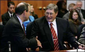 Gov. Bob Taft, left, and UT President Lloyd Jacobs attended the first trustees meeting of the newly merged university.