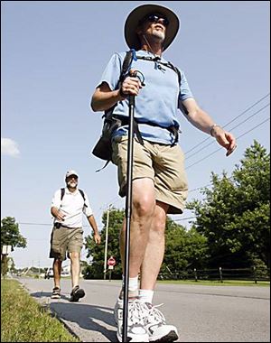 Dave Pavlick leads the way as Johnathon Ross follows along Walbridge Road as the pair heads toward Northwood.