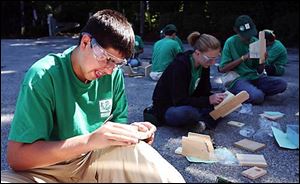 Sylvania Youth Conservation Corps member Rob Pfeiffer builds a bird house.