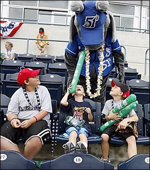 Joe Zarn, 10, left, Jake Kokinda, 7, and Zach Kokinda, 9, of Port Clinton get a visit from Las Vegas 51s mascot Cosmo.