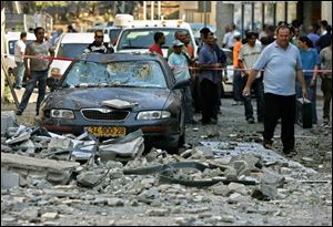 Israelis examine the scene of a rocket attack by Hezbollah guerillas on the northern Israeli town of Safed. A barrage of seven rockets were fired at the town by guerillas in southern Lebanon. 