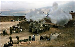 An Israeli artillery unit fires across the border into southern Lebanon from a position on the frontier in the northern Israel town of Zaura.