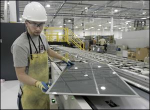 Nick Lesinszki works on a panel at a First Solar plant in Perrysburg Township. The firm is a leading developer of thin solar panels marketed for household use.