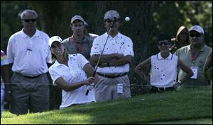 Reilley Rankin hits out of the sand trap on hole No. 7 where she bogeyed.