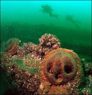 Scuba divers pass the ruins of the George A. Marsh, one of the shipwrecks that attract tourists to Kingston, Ont.